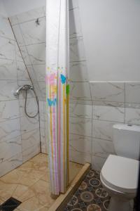 a shower curtain in a bathroom with a toilet at Ośrodek BEAVER in Wiele