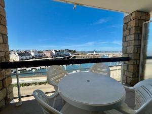 einen weißen Tisch und Stühle auf einem Balkon mit Meerblick in der Unterkunft Appartement Quiberon, 2 pièces, 4 personnes - FR-1-478-78 in Quiberon