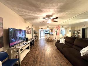 a living room with a couch and a flat screen tv at Bayshore Yatch Tennis Condo 2br 3 beds, Walking Distance to Beautiful Quite Beach in Clearwater Beach