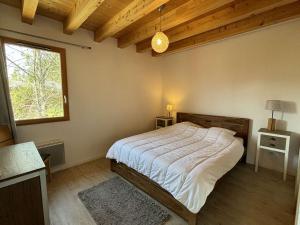 a bedroom with a large bed in a room with a window at Chalet Notre-Dame-de-Bellecombe, 8 pièces, 15 personnes - FR-1-595-1 in Notre-Dame-de-Bellecombe