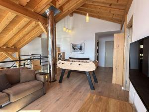 a living room with a pool table and a couch at Chalet Notre-Dame-de-Bellecombe, 8 pièces, 15 personnes - FR-1-595-1 in Notre-Dame-de-Bellecombe