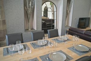 a table with wine glasses on top of it at La Chapelle Industrielle in Issenheim +11 photos