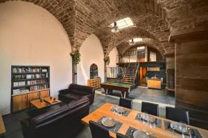 a living room with a table and a pool table at La Chapelle Industrielle in Issenheim