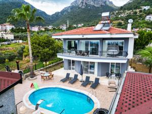 a house with a swimming pool on a roof at alanya polat holiday village in Alanya
