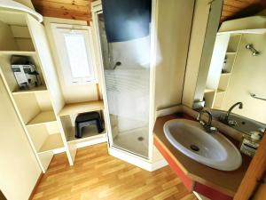 a small bathroom with a sink and a shower at Chalet climatisé 6 pers., piscine chauffée, parking, terrasse teck, calme près plages et commerces - FR-1-607-59 in Agde +7 photos