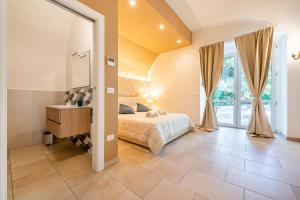a bedroom with a bed and a sink and a mirror at Palazzo Biscilia with private pool - Happy Rentals in Bisceglie