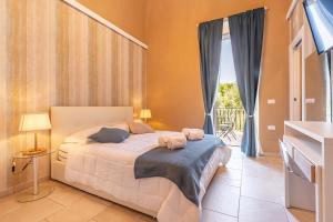 a bedroom with a bed and a large window at Palazzo Biscilia with private pool - Happy Rentals in Bisceglie