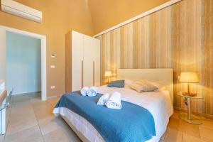a bedroom with a bed with two towels on it at Palazzo Biscilia with private pool - Happy Rentals in Bisceglie +36 photos