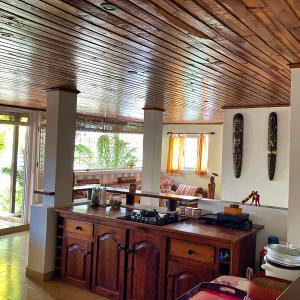 a kitchen with a wooden ceiling and a counter top at Villa Madirokely in Nosy Be