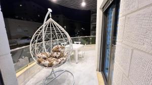 a bird cage with donuts in it on a balcony at شقق عمو سامي بغرفة نوم 1 in Amman