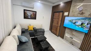 a living room with a couch and a flat screen tv at شقق عمو سامي بغرفة نوم 1 in Amman