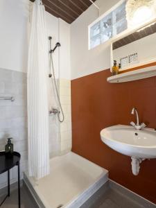 a bathroom with a sink and a shower at Endretro Apartments in Siófok +50 photos