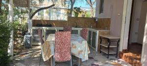 a patio with a table and chairs on a balcony at Novruzi Complex in Vlorë