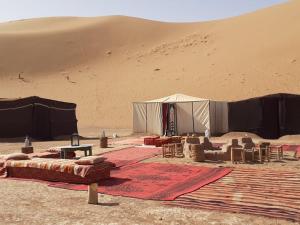 a tent in the middle of a desert at Chigaga Desert Camp in Mhamid