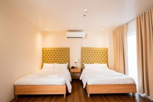 Postel nebo postele na pokoji v ubytování JVJ Hotel