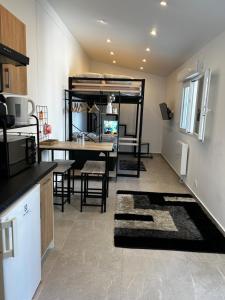 a kitchen and living room with a loft bed at Casa Enna in Rueil-Malmaison