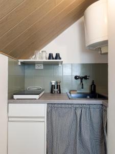 a kitchen with a sink and a counter top at Endretro Apartments in Siófok