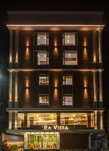 a building with a lit up facade at night at Ra Vista in kolkata