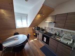 a kitchen with a table and a counter top at Grand T2 proche canal de Nantes à Brest. in Châteauneuf-du-Faou