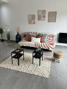 a living room with a couch and a table at Lumineux Appart à Disneyland in Montry