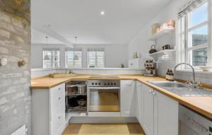 a kitchen with white cabinets and a sink at 3 Bedroom Awesome Home In Hornbæk in Hornbæk