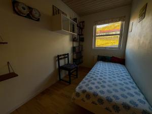 a small bedroom with a bed and a window at Sea & Mountain View 3 Bedroom in Leynar
