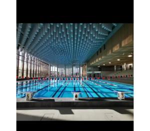 une grande piscine avec un grand plafond dans l'établissement Casa Enna, à Rueil-Malmaison