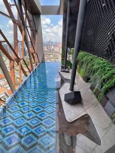 a swimming pool on the top of a building at The Scarletz By RSR in Kuala Lumpur