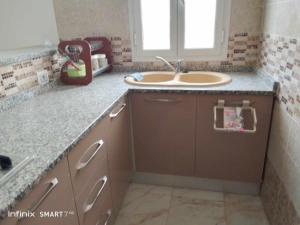 a kitchen with a sink and a counter top at Résidences Porte de désert Douz in Douz