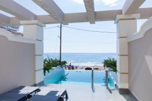 a view of the ocean from the balcony of a hotel at Agios Gordios Boutique Resort in Agios Gordios