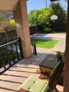 a patio with a table and a chair and a table and a basketball hoop at Family house room in Salacgrīva