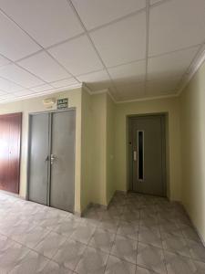 HOTEL MIRAMAR في توريبلانكا: غرفه فاضيه فيها بابين في عماره