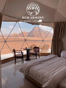a bed in a tent with a view of the desert at Rum Armony camp in Wadi Rum