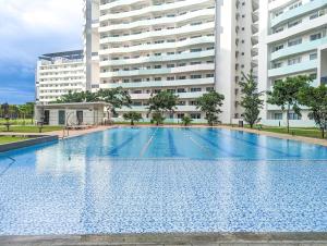 an empty swimming pool in front of a building at Bright & Stylish Studio Condo in Commonwealth, UP Diliman in Manila