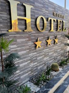 a hotel sign with stars on a wall at Hotel Golden Star in Taounate