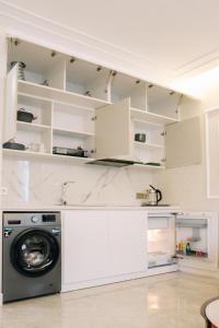 a laundry room with a washer and dryer at Luxurious Mamu Apartment in Batumi