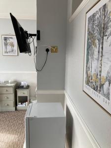 a room with a desk and a tv on a wall at Braemar in Weymouth +24 photos