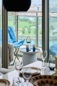 a table with glasses on it with a view of a room at Casa YONNA Naha in Naha