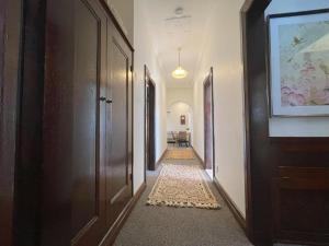 a corridor of a hallway with doors and a rug at Globe Apartments in Wagga Wagga