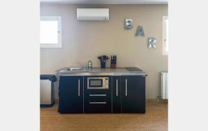 a kitchen with a sink and a stove top oven at Le Jardin de Celina in Valensole