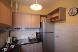 a kitchen with a sink and a refrigerator at Sunrise in Baveno in Baveno