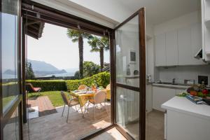 a kitchen and dining room with a table and chairs at Residenza due Laghi Pool Lake View in Brezzo