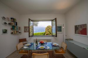 a dining room with a table and a window at Residenza due Laghi Pool Lake View in Brezzo