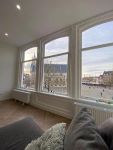a living room with a large window view of a city at Apartement City Center Gouda: View Deluxe in Gouda