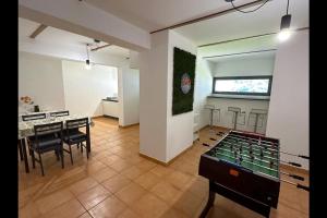 a large room with a table and chairs and a room with aocoustic at Riflessi sul lago apt – Laglio in Laglio