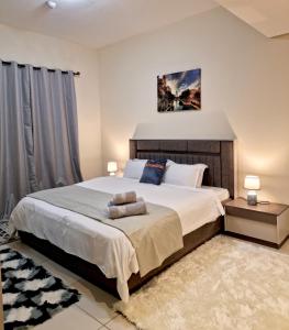 a bedroom with a large bed in a room at Deluxe Rooms in Al Mamzar SHJ Shared bathroom in Sharjah