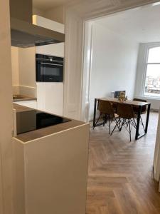 a kitchen with a table and a dining room at Apartement City Center Gouda: View Deluxe in Gouda