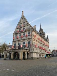 a large building with red signs on it at Apartement City Center Gouda: View Deluxe in Gouda