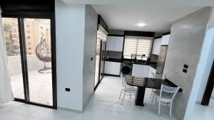 a kitchen and dining room with a table and chairs at شقة رووف اطلاله رائعه in Amman