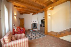 a living room with a couch and a fireplace at La Casa nel Borgo in Nebbiuno